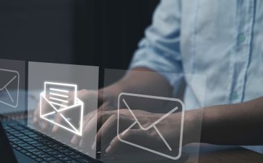 Businessman typing laptop computer to open and send email.